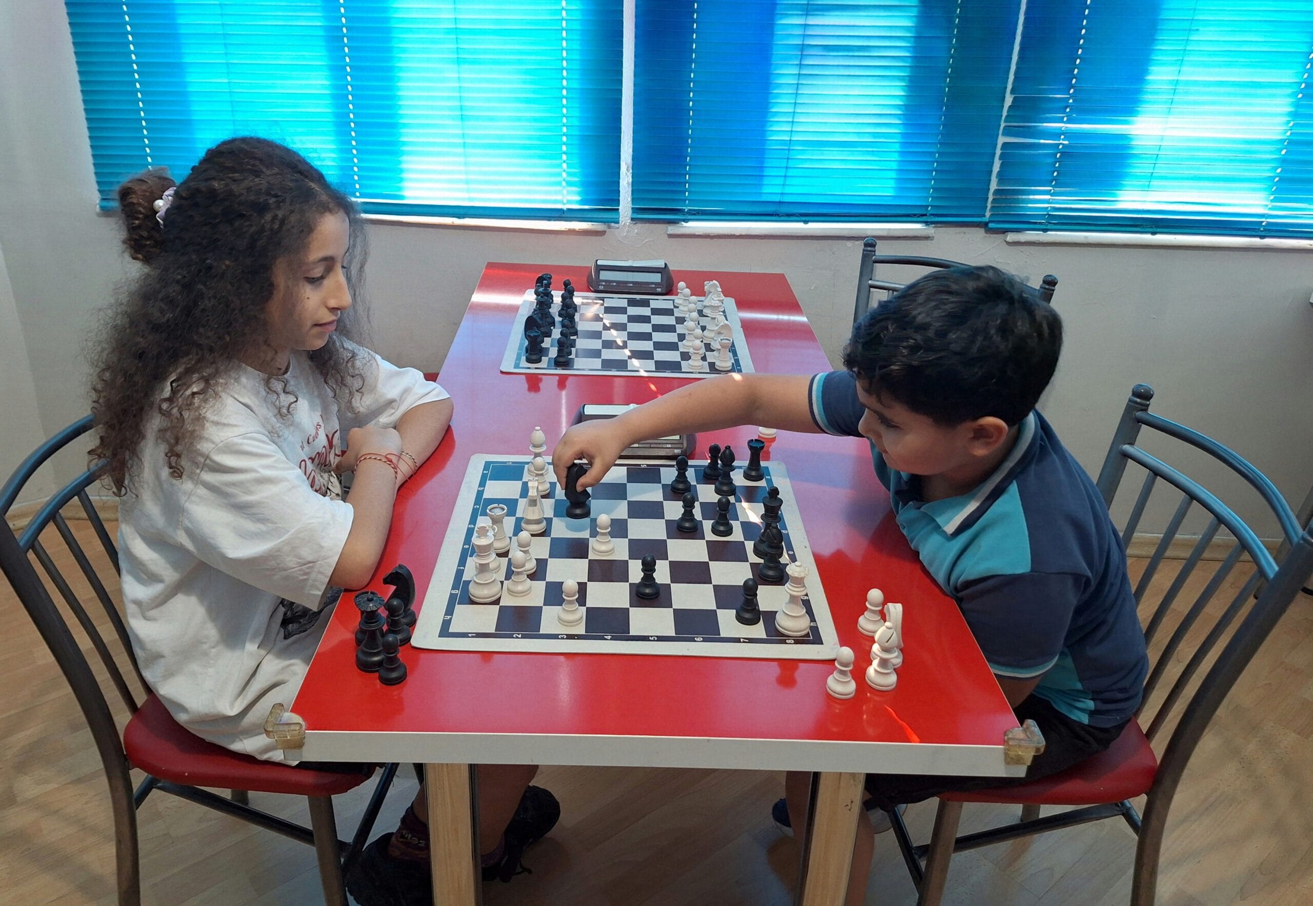 Chess Club Antalya students playing a training game during a face-to-face chess lesson